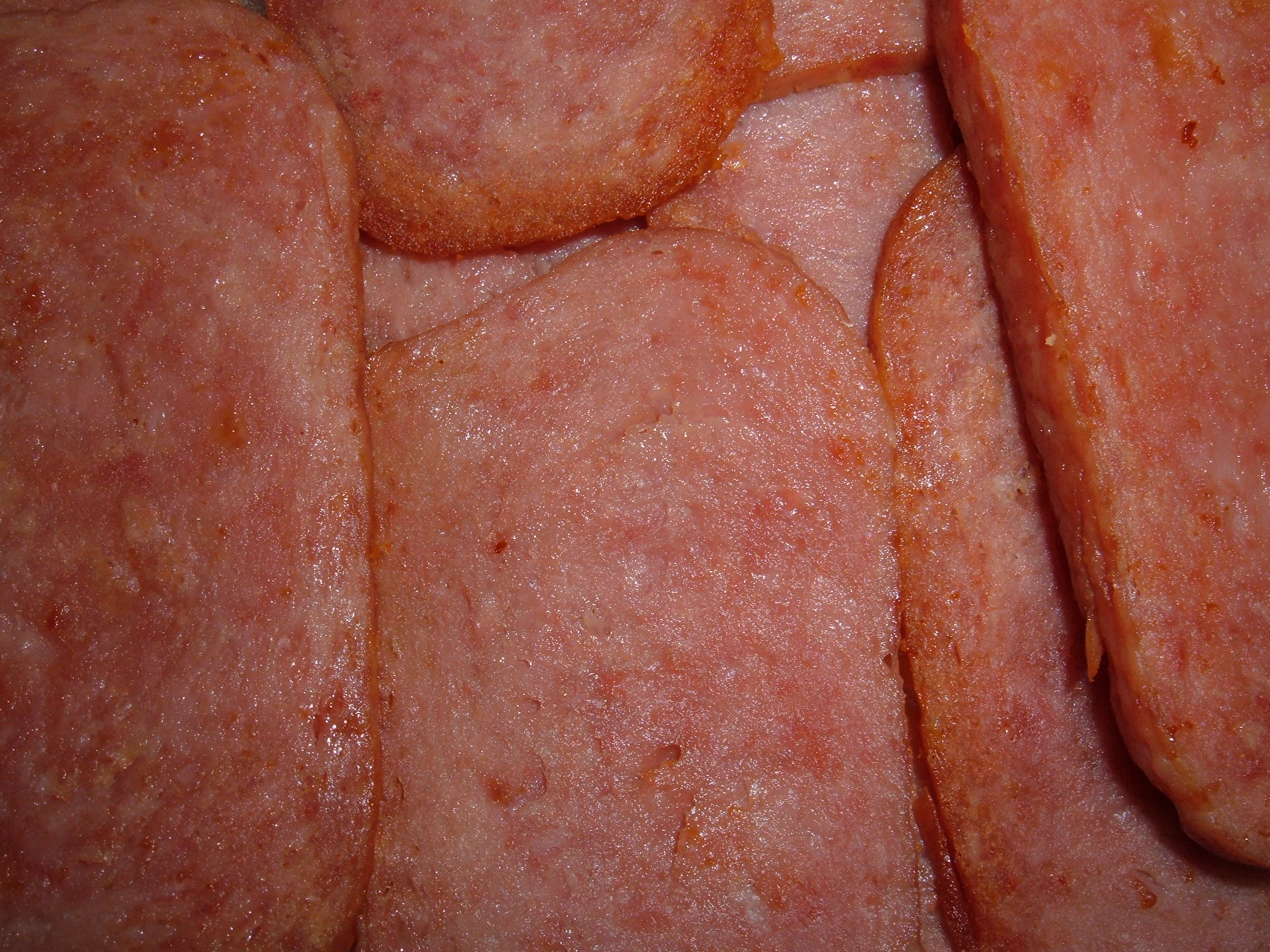 Fried Spam slices on a plate